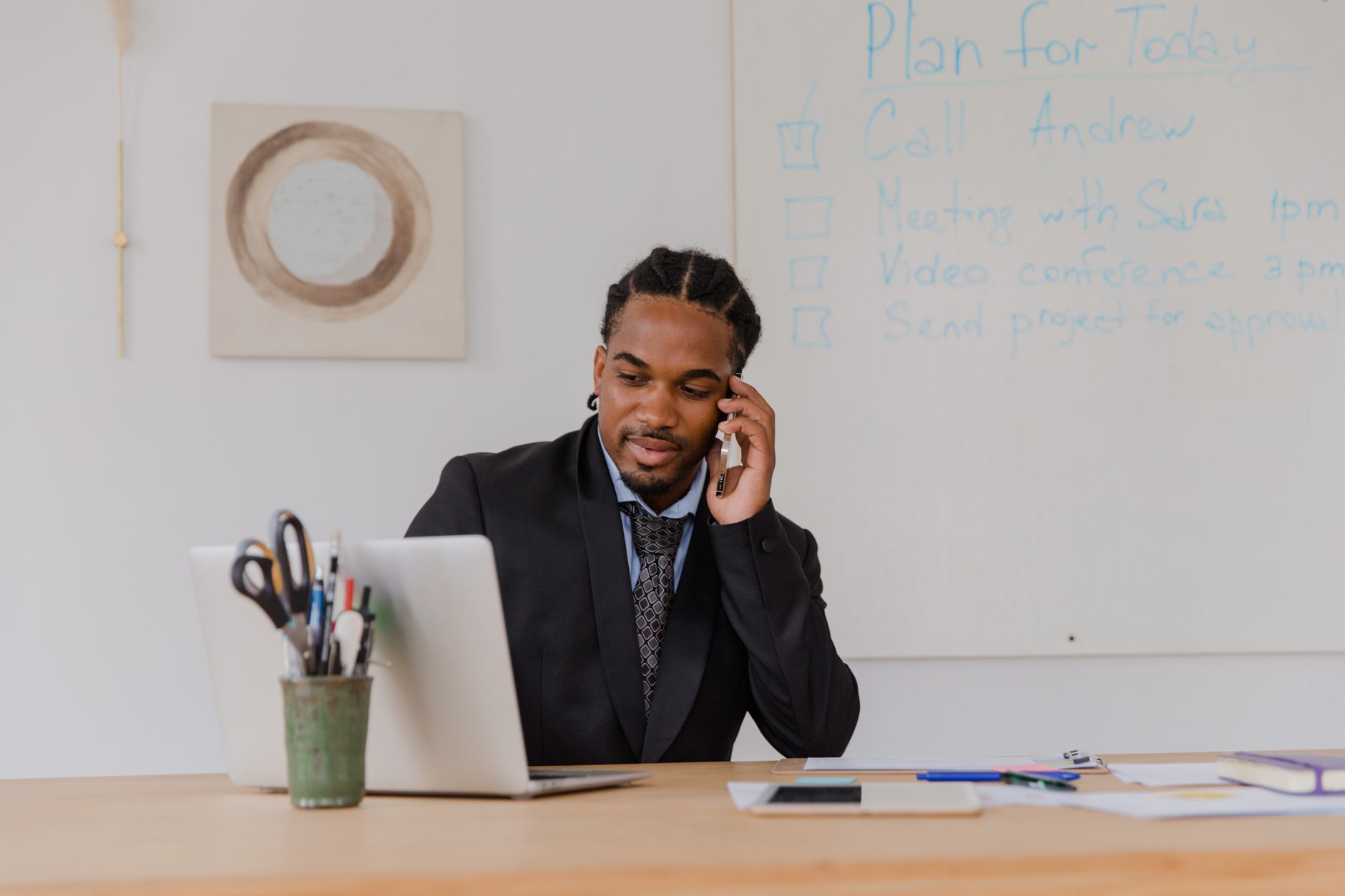 A businessman making a phone call in a modern office setting, working at a desk. — How Influencer Agencies in Melbourne Are S