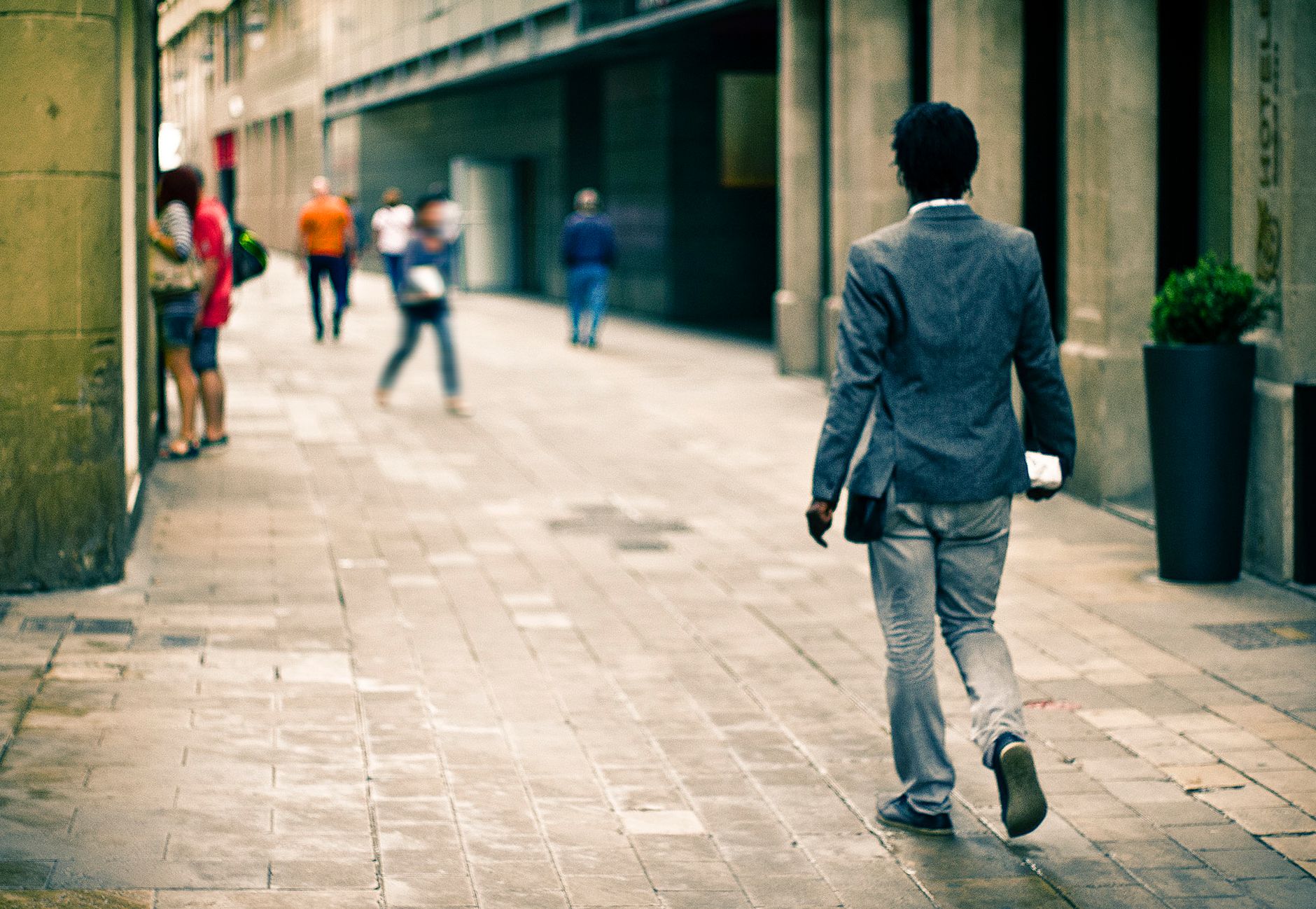 A man in a suit walks through a city alley, reflecting urban life and fashion. — How to check card condition online providing