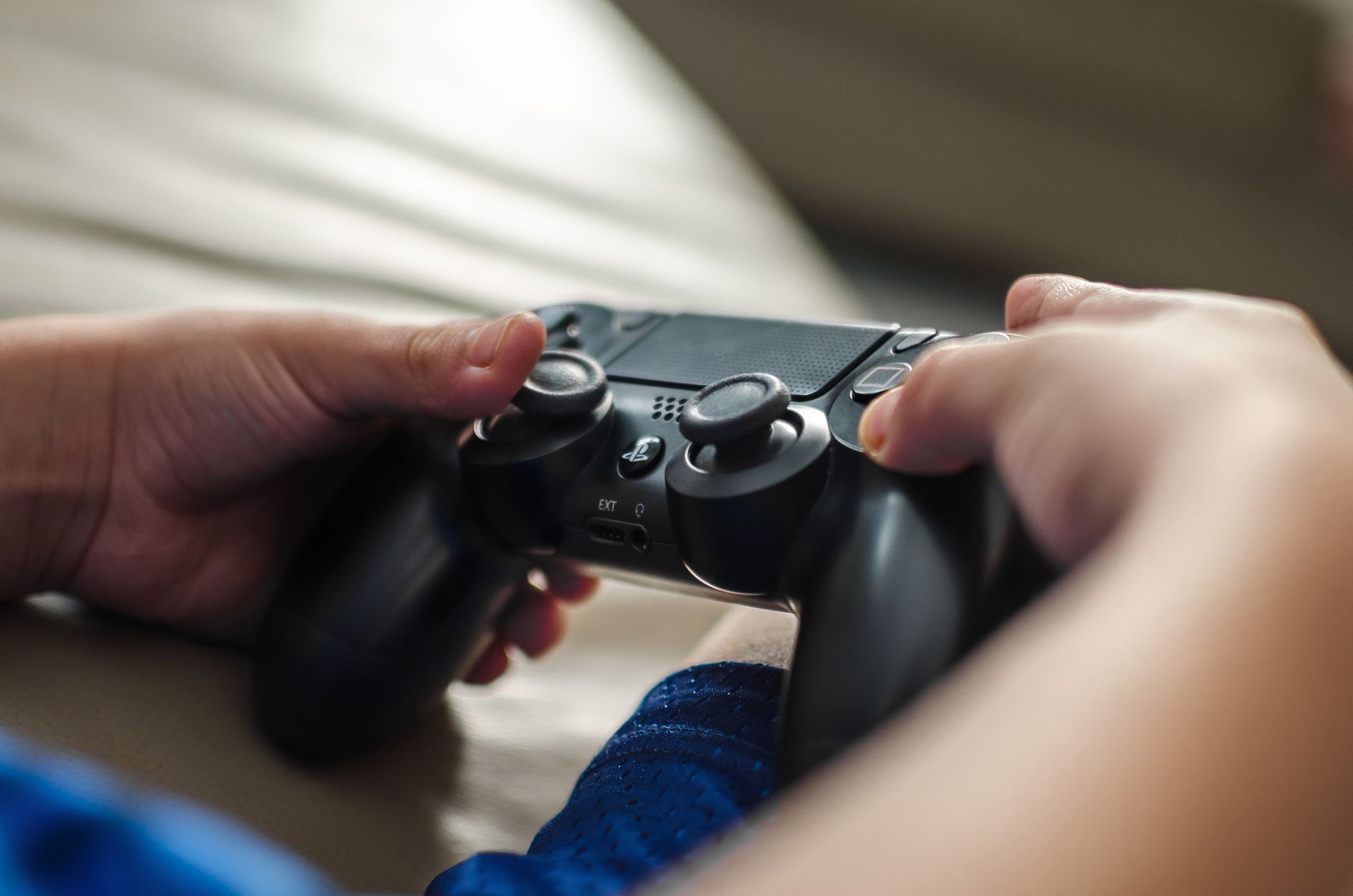 Close-up of hands holding a game controller, ideal for gaming and technology themes. — iGaming Payment - Secure Online Paymen