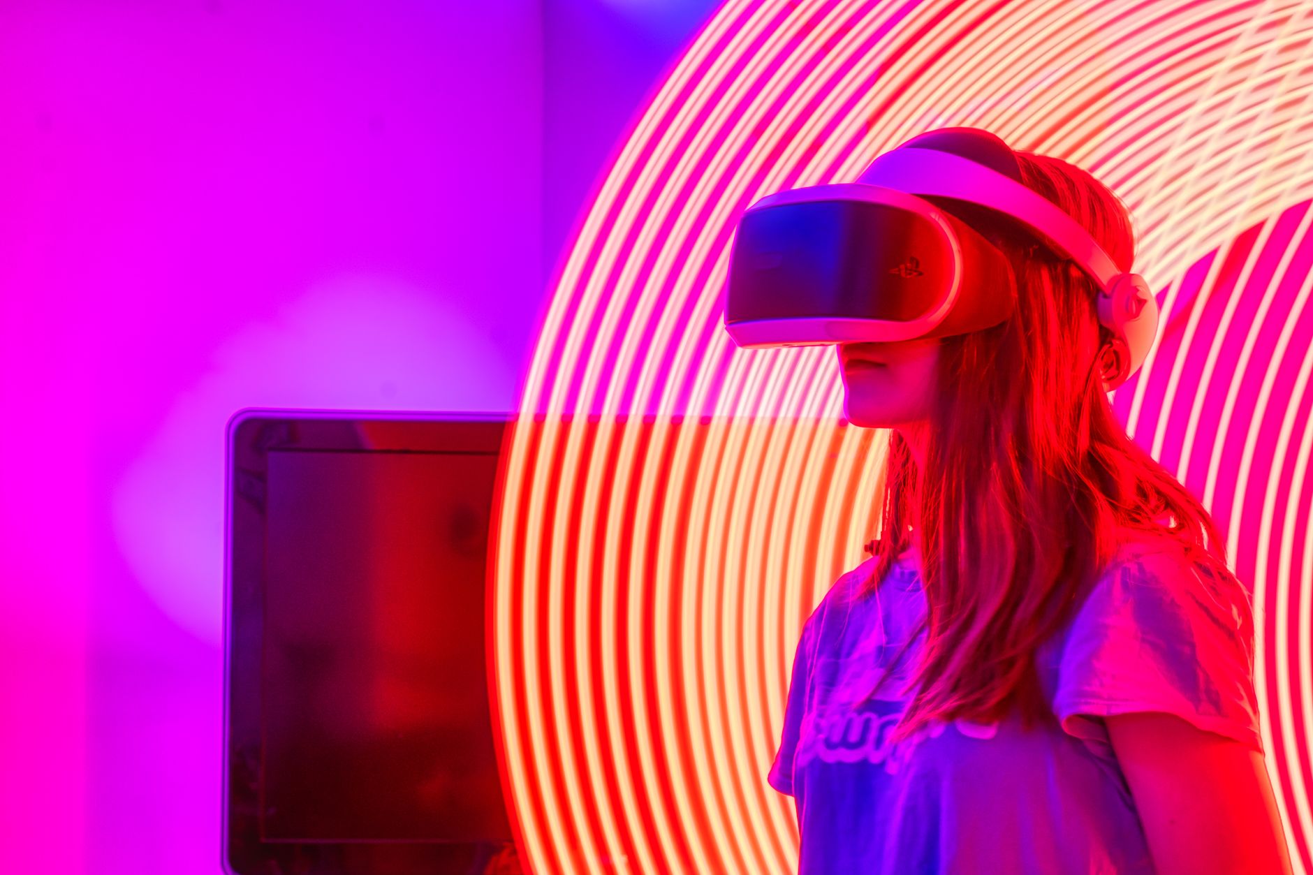 A woman wearing VR glasses immersed in a neon-lit environment with swirling lights. — Nextcloud Hosting: Essential Insights f